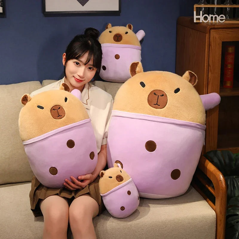 Woman sitting on a couch with large, cute animal-shaped kawaii pillows in a cozy room.