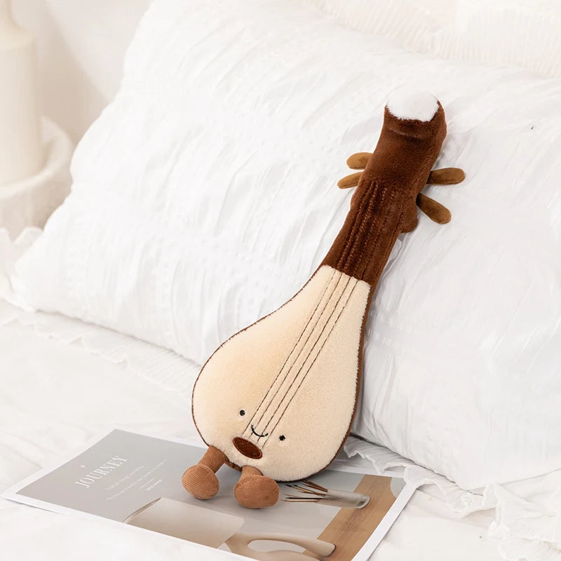 Plush kawaii toy resembling a lyre on a white surface