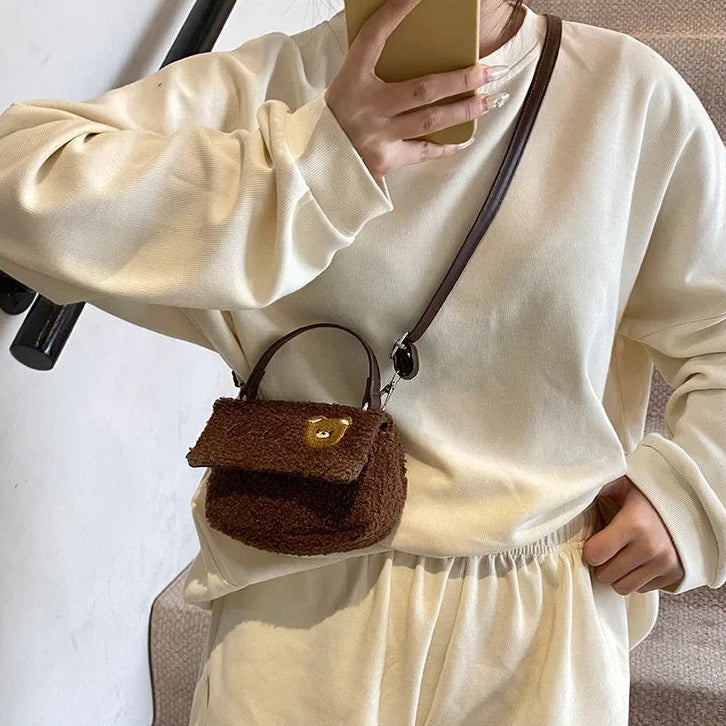 Person wearing a white outfit with a brown textured Kawaii handbag