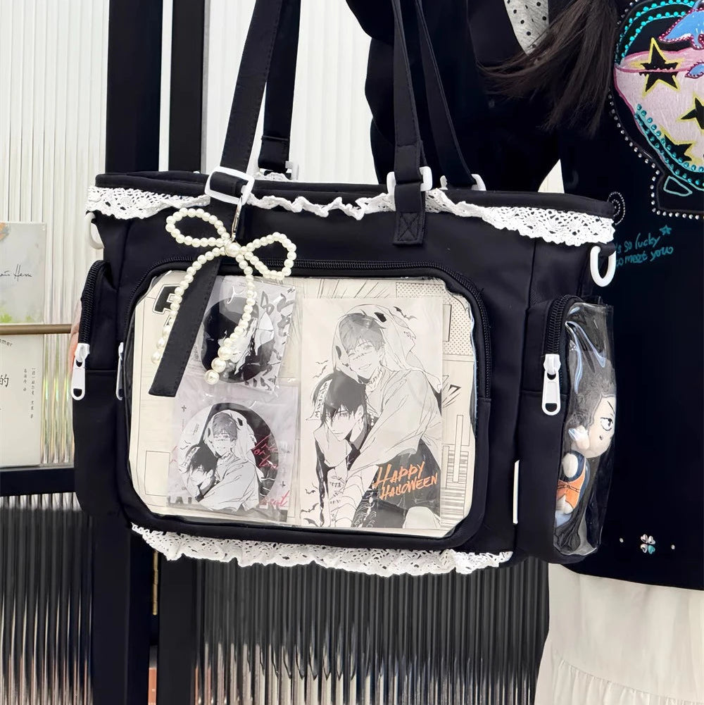 Black Kawaii handbag with white lace details held by a person wearing a colorful sweater.