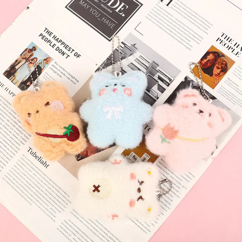 Set of four kawaii fluffy keychains on a newspaper background