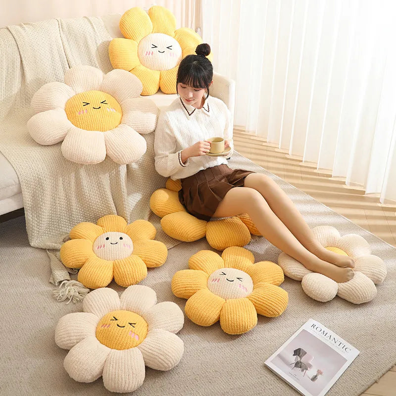 Woman sitting on a couch surrounded by sunflower-shaped kawaii cushions with smiling faces.