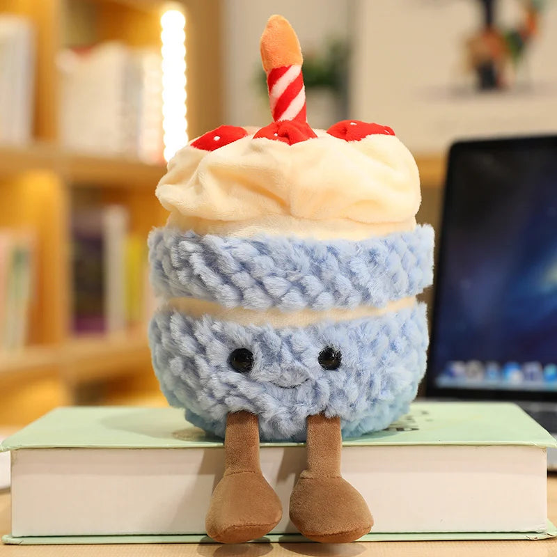 Plush kawaii toy resembling a birthday cake with a candle on top, sitting on books.