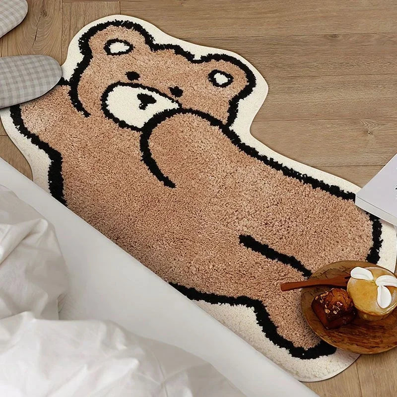 Kawaii bear-shaped rug on a wooden floor with a bowl of snacks in the foreground.