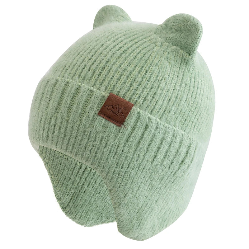 Green knit Kawaii beanie with brown patch on a white background