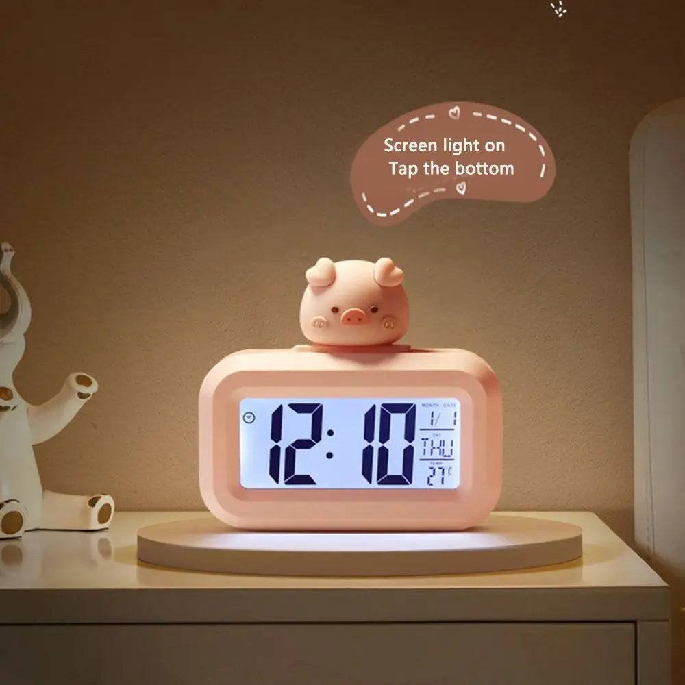 Pink pig-shaped kawaii clock with digital display on a shelf