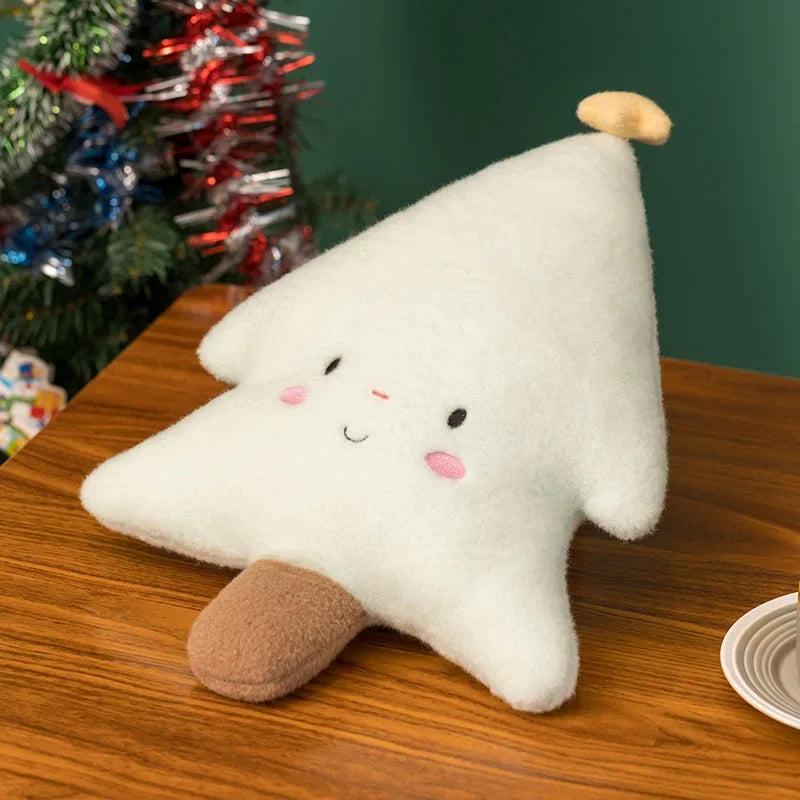 White kawaii plush star toy with a smiley face on a wooden surface with a Christmas tree in the background.