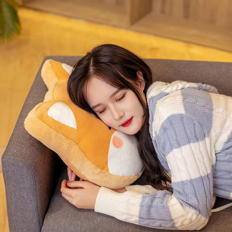 Woman lying on a couch with a plush fox kawaii pillow and blanket