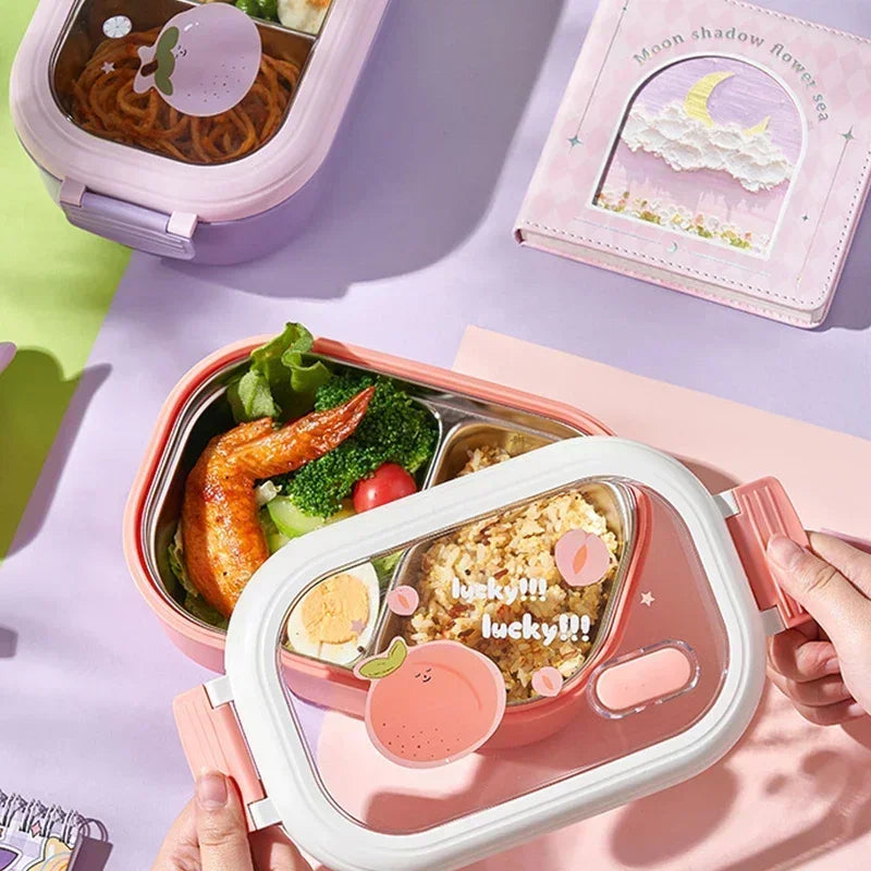 Pink kawaii bento box with food compartments on a purple surface