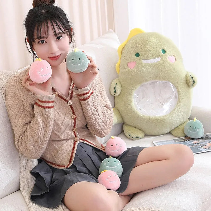 Person holding small kawaii plush toys with a large green plush toy on a couch.