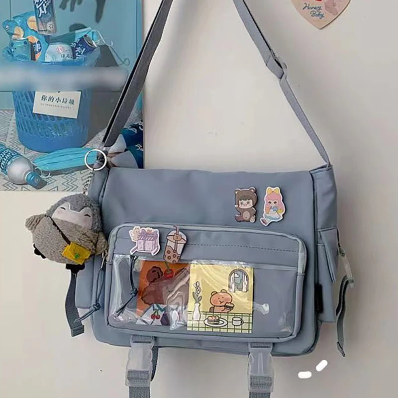 Gray Kawaii shoulder bag with cartoon character decorations on a white background