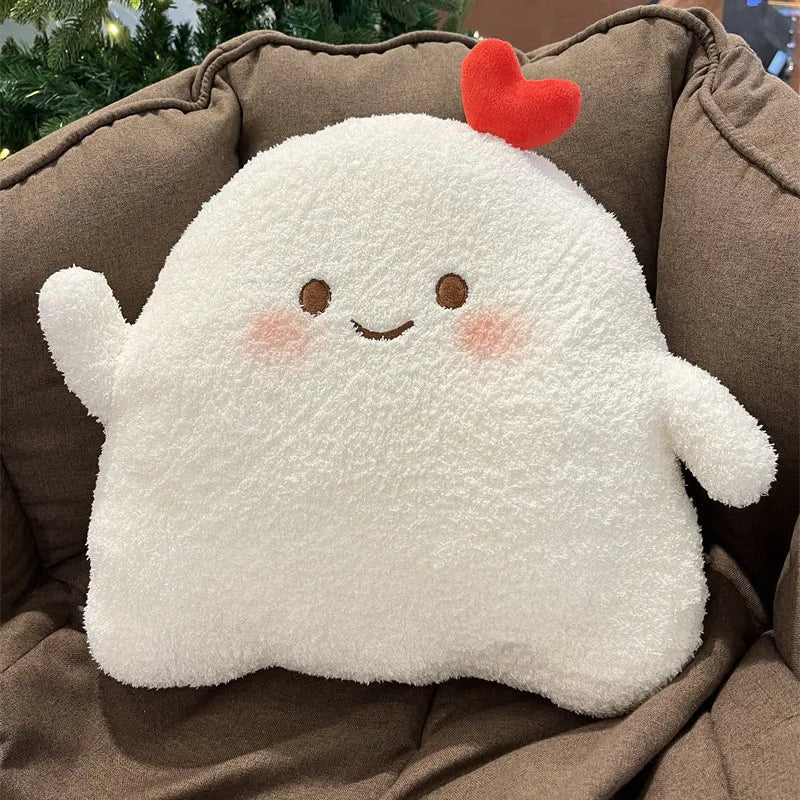 Cute kawaii plush ghost toy with a red heart on a brown cushion