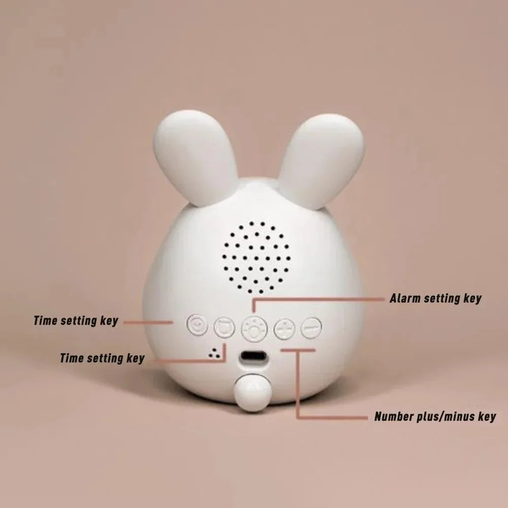 White rabbit-shaped kawaii alarm clock with labeled buttons on a beige background