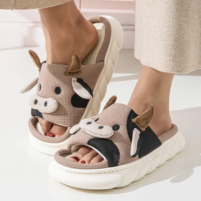 Cow-themed kawaii slippers worn by a person on a light background