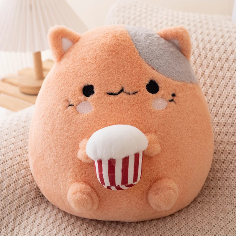 Plush toy resembling a kawaii cat with popcorn on a soft surface