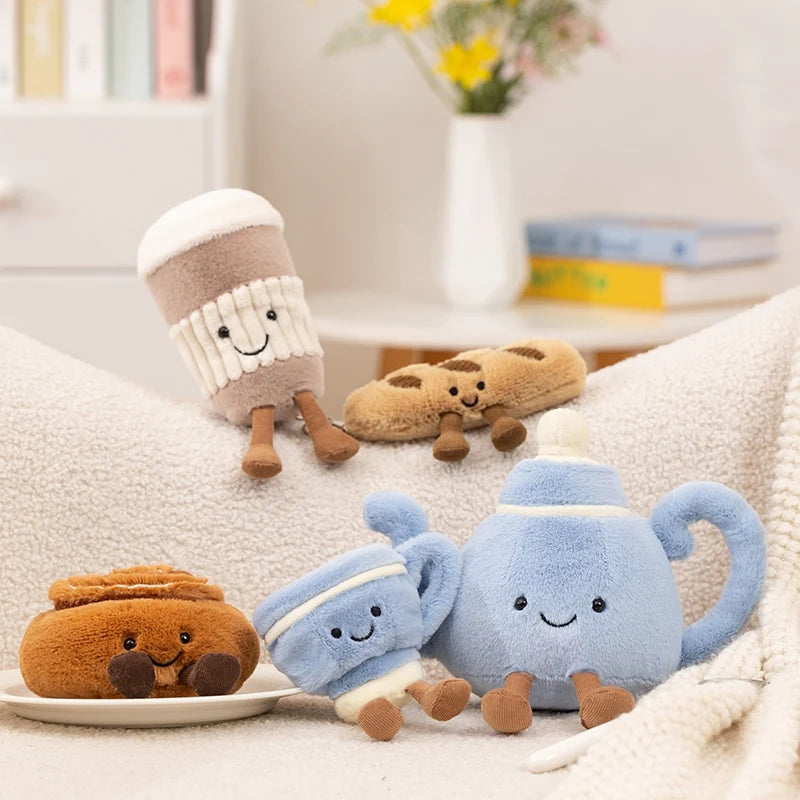 Set of cute plush kawaii toys including a teapot, mug, and bread on a soft surface.