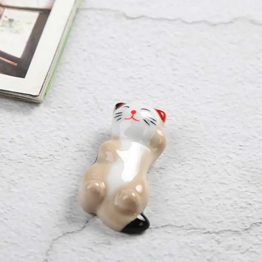 Ceramic kawaii cat figurine on a marble surface