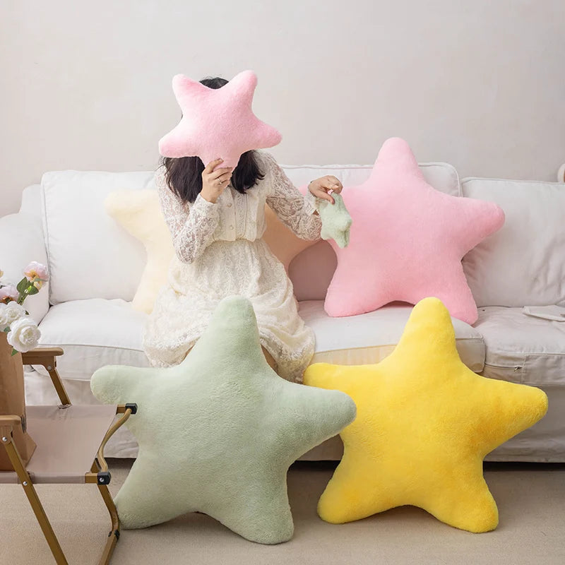 Person sitting on a couch with star-shaped kawaii cushions in various colors.