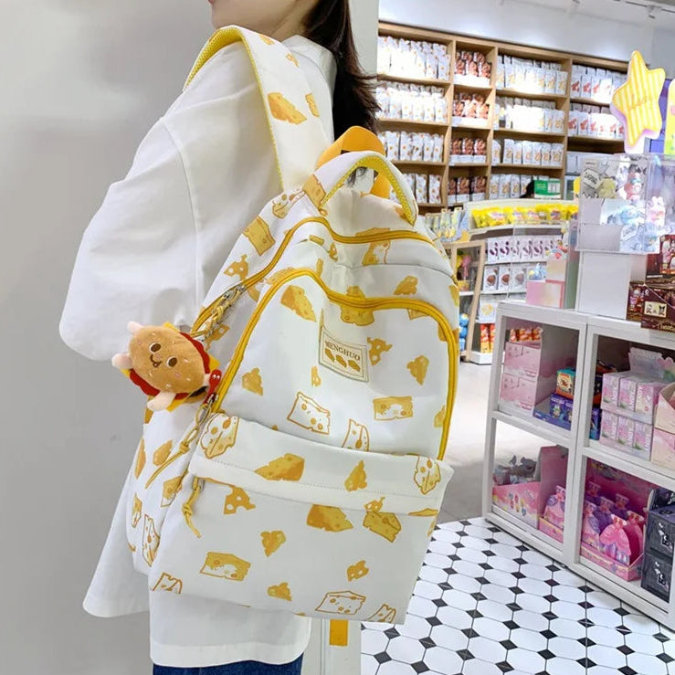 Person wearing a white backpack with Kawaii yellow patterns in a store setting