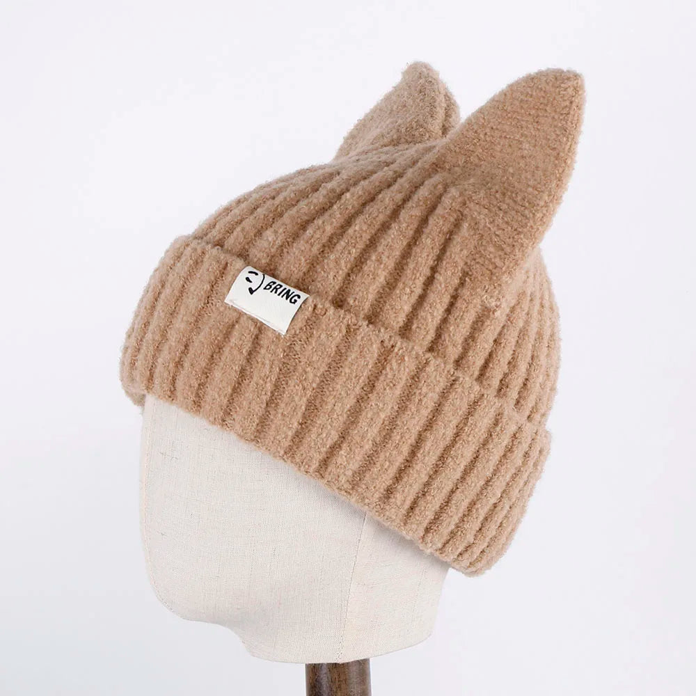 Beige knit Kawaii beanie with fox ears on a mannequin head against a white background