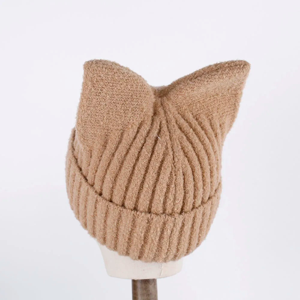 Beige knitted cat ear Kawaii hat on a mannequin head against a white background