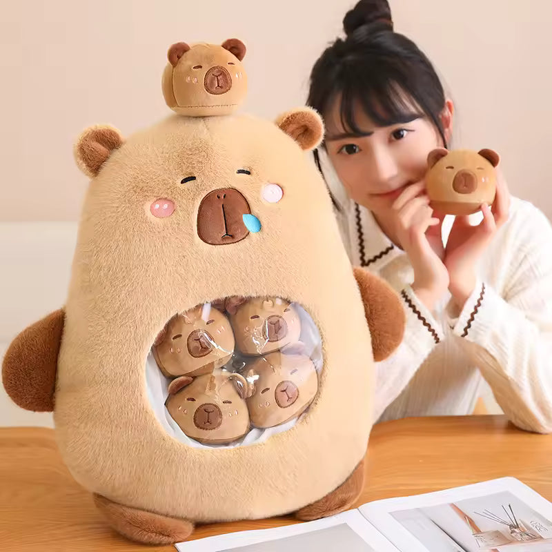 Large kawaii plush toy with small bear heads on a wooden table, with a person holding one of the bear heads.