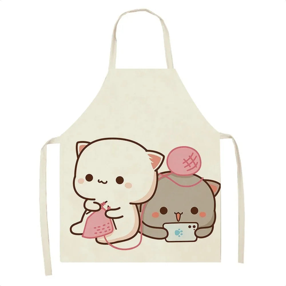 Kawaii cartoon cats on a white apron with pink yarn.