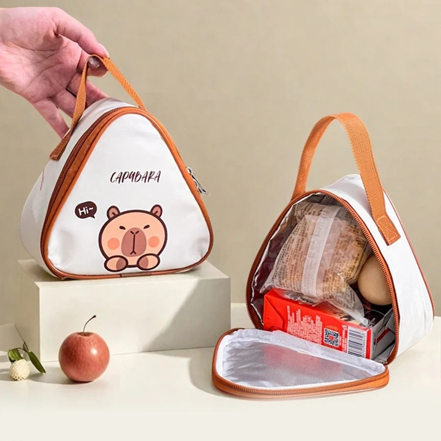 White and brown insulated lunch bag with kawaii cartoon bear design, held by a hand.