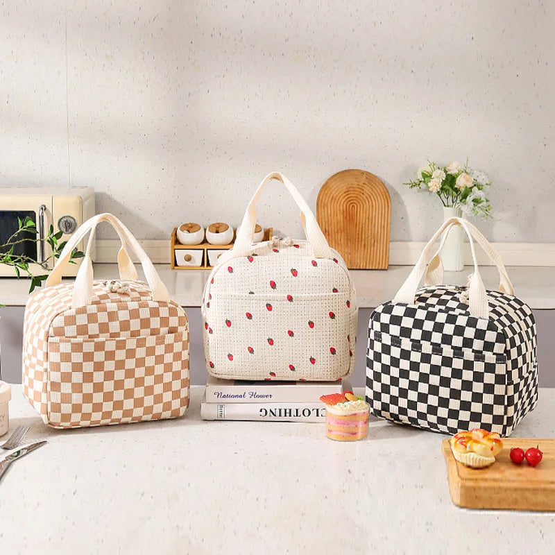 Three kawaii patterned bags on a kitchen counter with books and food items.