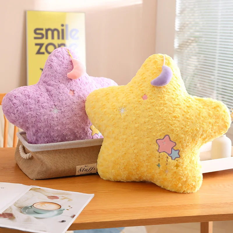 Two star-shaped kawaii plush toys, one purple and one yellow, on a wooden surface with a magazine in the background.