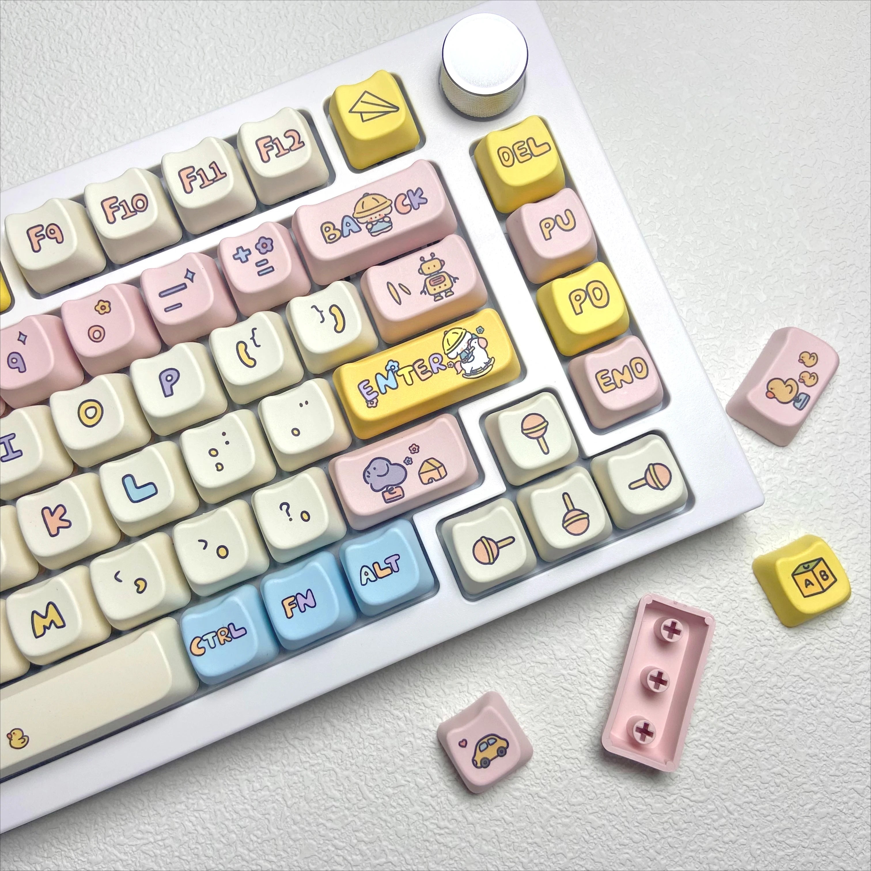 Keyboard with Kawaii colorful custom keycaps on a light background