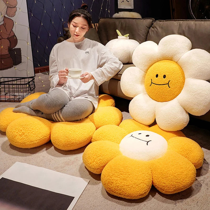 Person sitting on a flower-shaped yellow kawaii cushion with a smiling face in a cozy room.