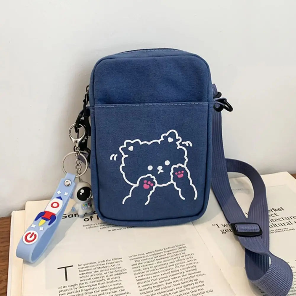 Navy blue Kawaii-style crossbody bag with a bear design on a book
