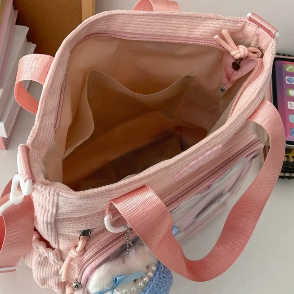Pink Kawaii backpack with multiple compartments on a blurred background