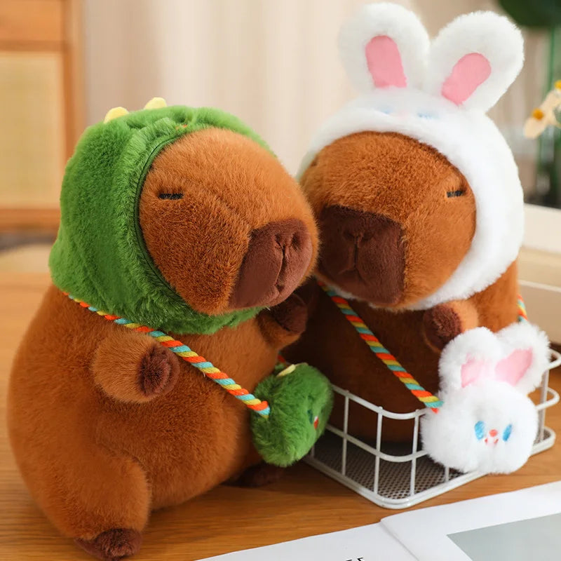 Two kawaii plush toys, one resembling a frog and the other a rabbit, sitting together on a wooden surface.