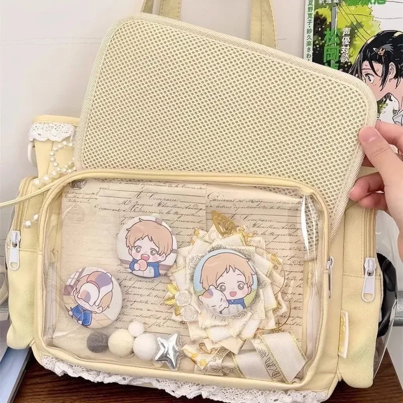 Beige Kawaii backpack with anime-themed accessories on a clear pouch