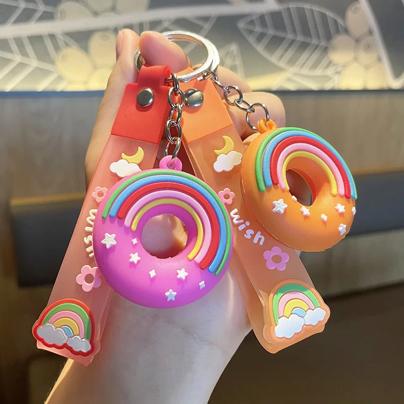 Colorful keychain with kawaii rainbow design held by a hand