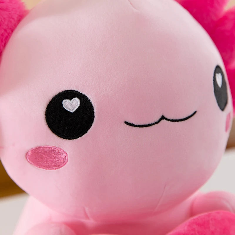 Close-up of a kawaii pink plush toy with a heart-shaped eye and closed eyes.