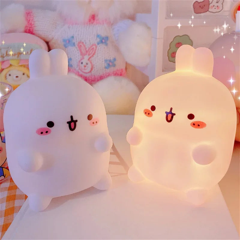 Two cute kawaii plush toys with animal ears on a soft surface.