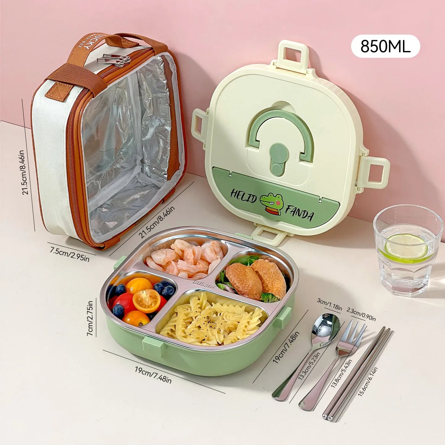 Green kawaii lunch box with compartments, cutlery, and a glass of water on a pink background