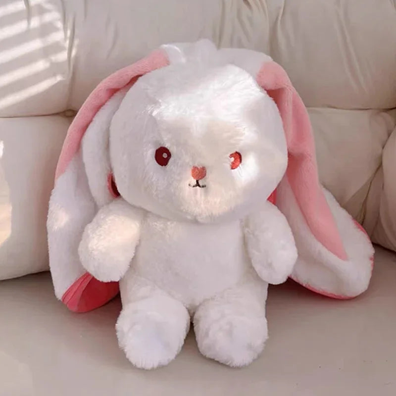 White kawaii plush bunny with pink ears on a light background