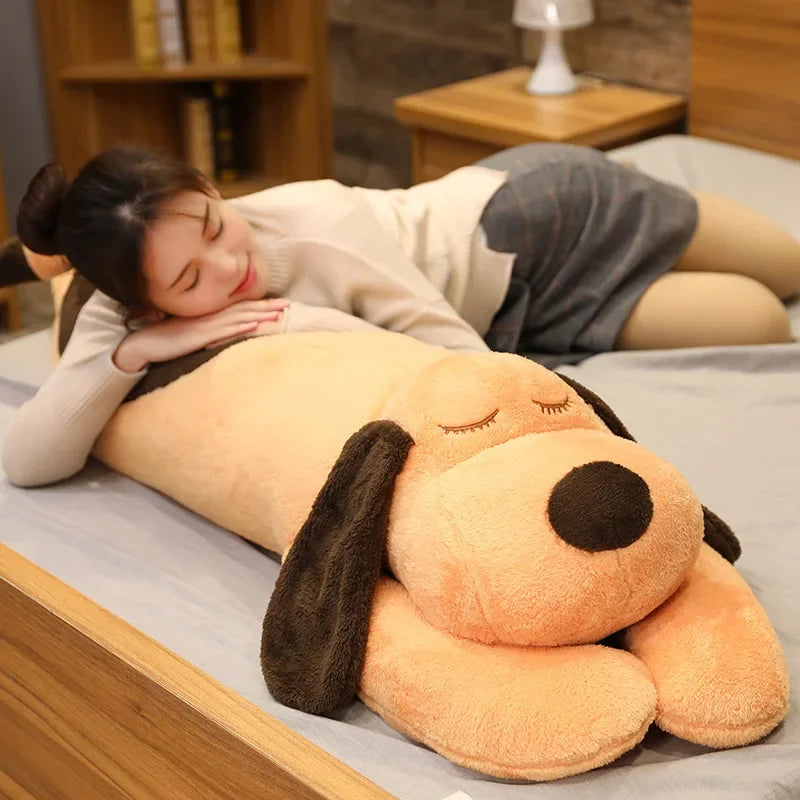 woman lying on top of a kawaii dog plush toy
