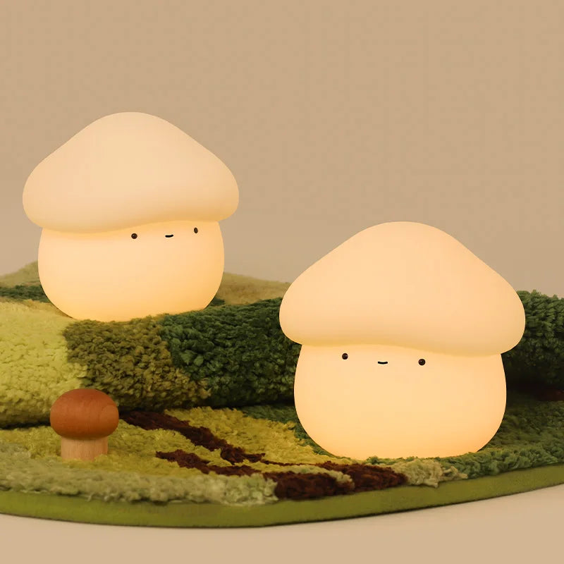 Two mushroom-shaped kawaii lamps on a textured green surface with a plain background