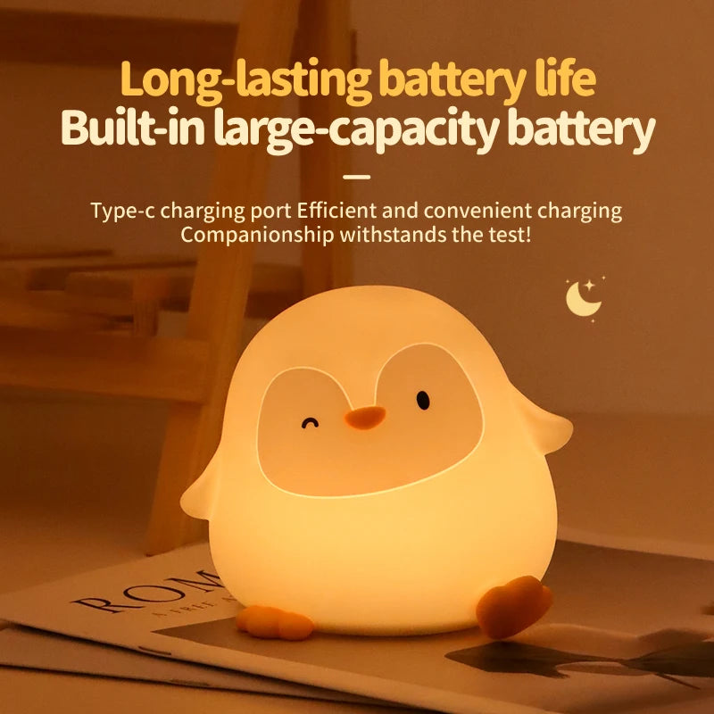Glowing penguin-shaped kawaii night light with text about battery life and charging on a blurred background.