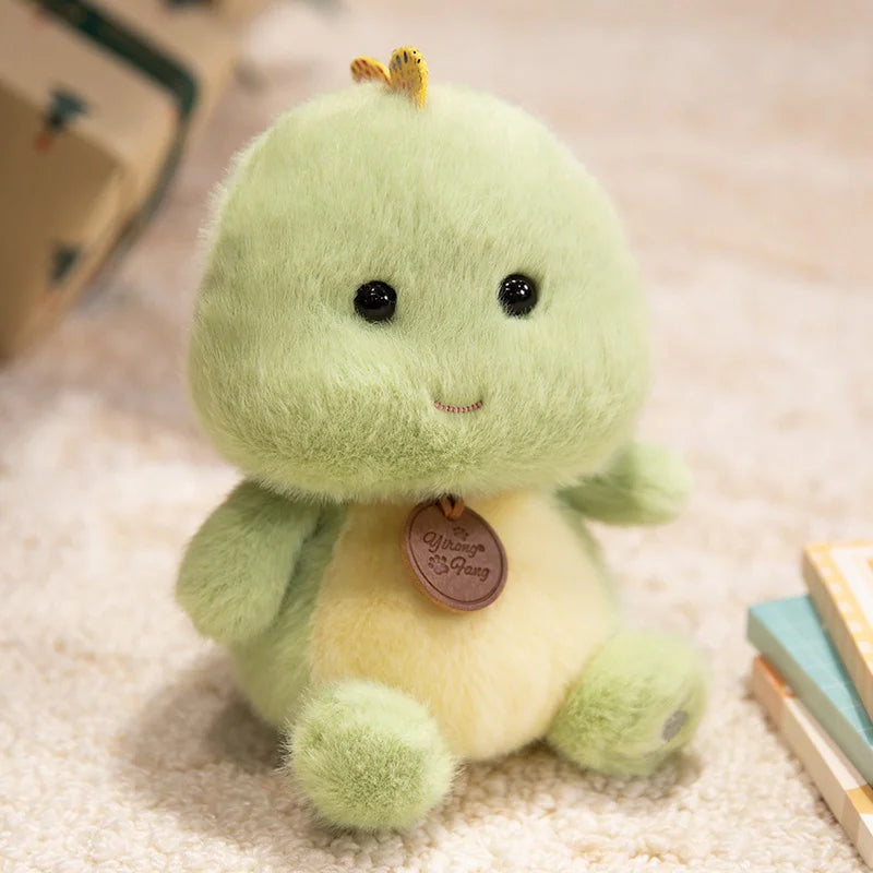Green plush kawaii toy with a yellow belly on a light-colored surface