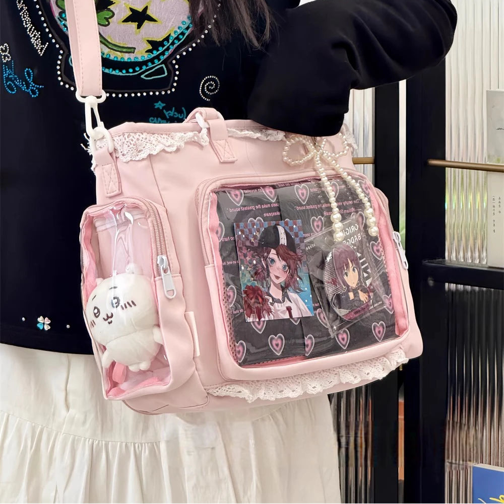 Person holding a pink Kawaii bag with anime character design and small plush toy.