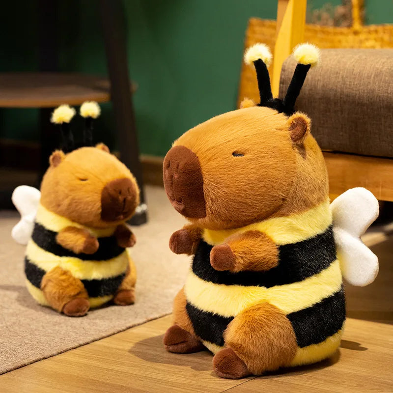 Two kawaii plush bee toys on a wooden floor with a blurred background