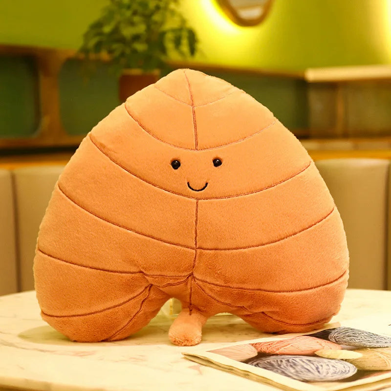 Plush toy shaped like a kawaii cartoonish brown object with a smiling face on a table.