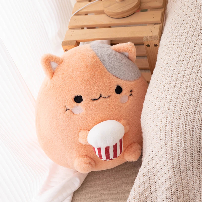 Plush toy resembling a kawaii bear with a cupcake on a wooden surface