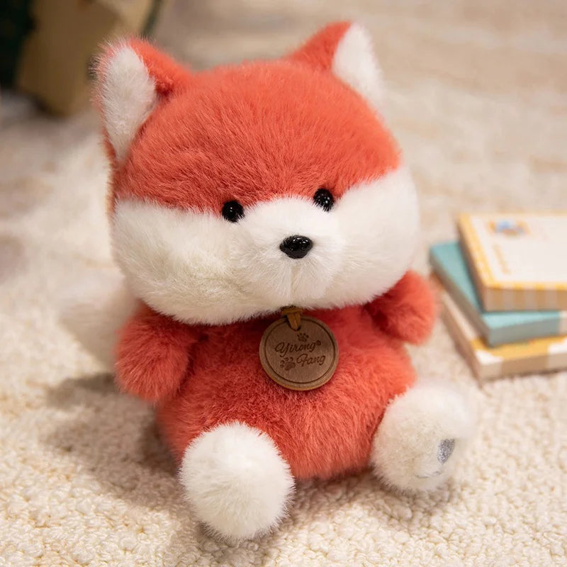 Plush fox kawaii toy with a gold tag on a soft surface
